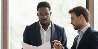 Two businessmen reviewing documents